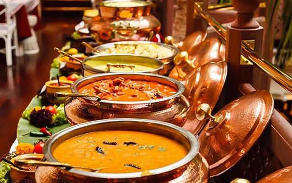 Bengali house warming and social event buffet — chafing dishes with rice, green curry, and stir-fried chicken — Parsha Caterer Kolkata