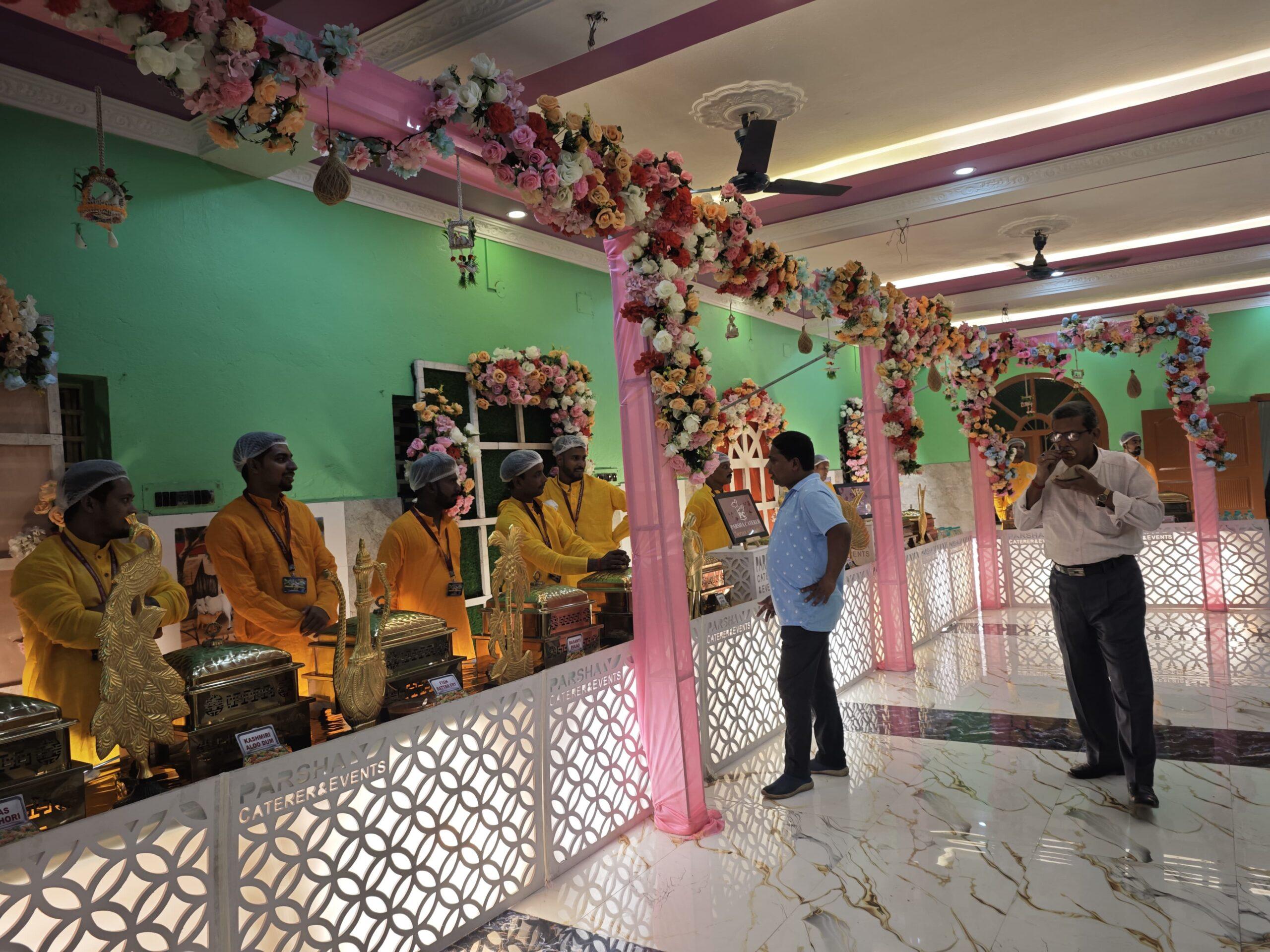 Customized catering counter with floral decor and guests