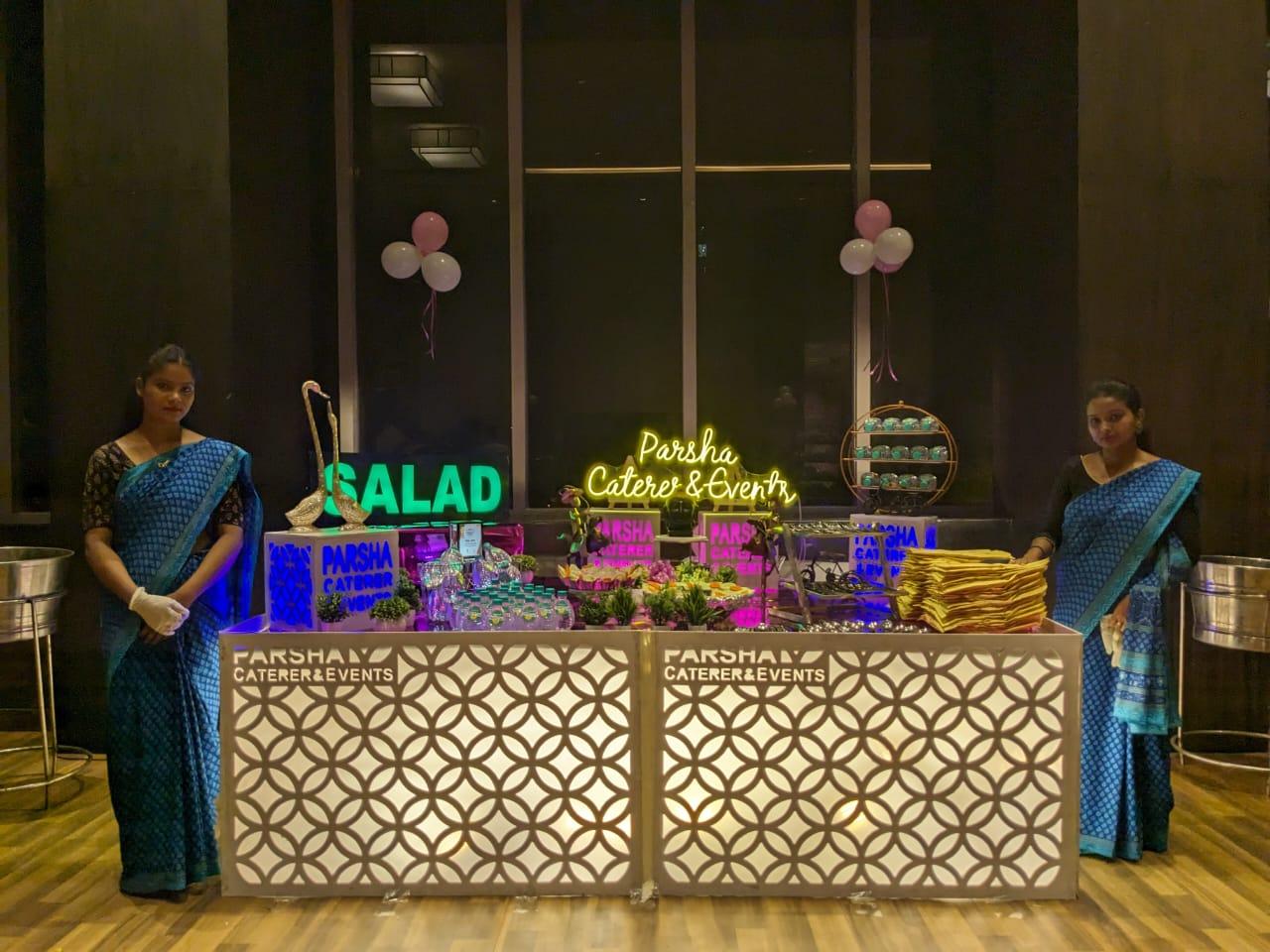 Catering station with staff preparing food hygienically